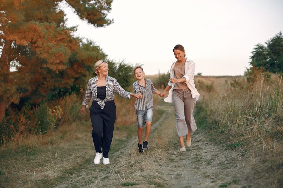 Family walking through the countryside at golden hour